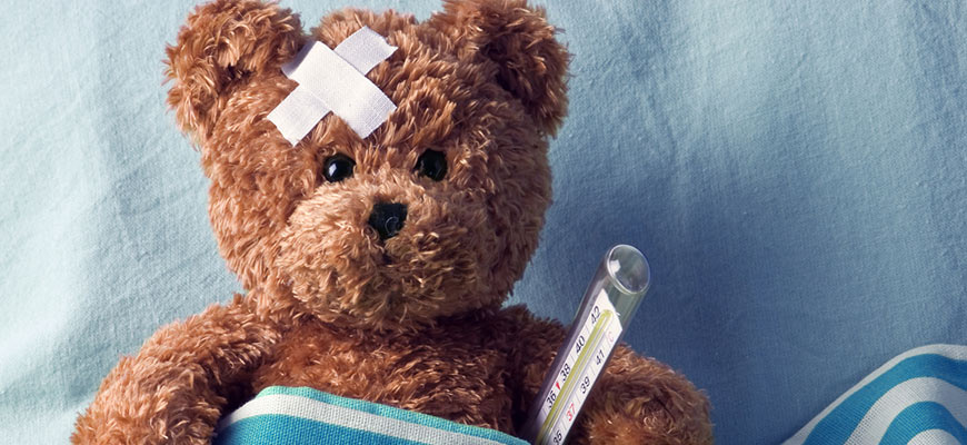 teddy bear with bandage and thermometer